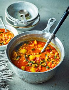 two bowls filled with soup next to each other on top of a cloth covered table