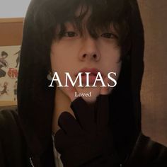 a person wearing a black hoodie with the words amas printed on it's face