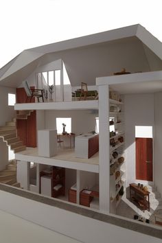 a model of a house with stairs leading up to the second floor