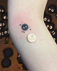 a small tattoo on the arm of a person's left leg with an eyeball