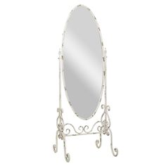 a white mirror sitting on top of a metal stand with an ornate design around it