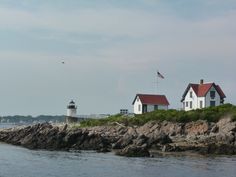 two lighthouses on top of a rocky shore