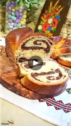 a loaf of cinnamon swirl bread sitting on top of a wooden cutting board