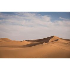 sand dunes in the desert under a blue sky