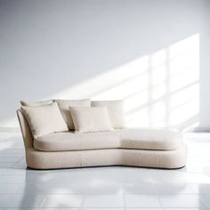 a white couch sitting on top of a tiled floor