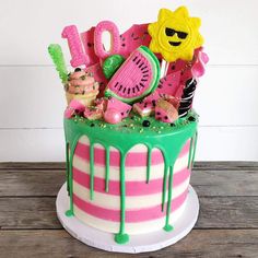 a cake decorated with pink, green and white icing