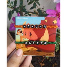 a hand holding up a card with the words hakuna and matata on it