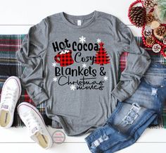 "Welcome to Maddy Paddy Designs Etsy Shop! This listing is for a Hot cocoa cozy blankets & Christmas movies shirt. This is a UNISEX Jersey Long Sleeve Tee. * If you would like to see the design on a different style shirt please message me. Solid colors * 100% cotton Athletic Heather * 90% cotton * 10 % polyester Deep Heather * 52% cotton * 48% polyester I suggest that you measure your shirt that you already own to compare sizing with the size chart in the photos. Please note that ALL SALES A Christmas Family Outfits, Joy Hope Love Peace Christmas, Blankets Christmas, Christmas Buffalo Plaid, Christmas Movie Shirts, Christmas Long Sleeve Shirts, Christmas Tee Shirts, Winter Shirts, Movie Shirts