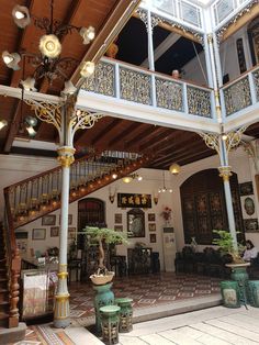 the inside of a building with stairs and chandeliers