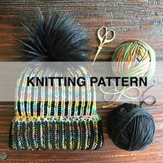 a knitted hat, ball of yarn and scissors on a wooden surface with the words knitting pattern