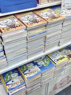 stacks of children's books are stacked on top of each other in a store