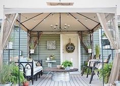 an outdoor covered patio with potted plants