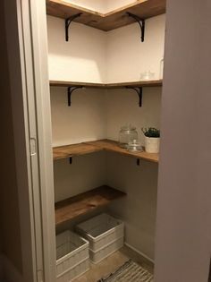 an empty walk in closet with shelves and bins