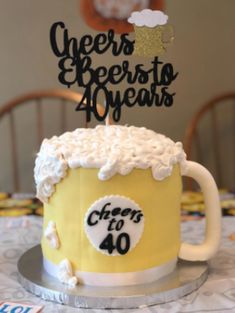 a cake that is sitting on top of a table with a beer mug in it