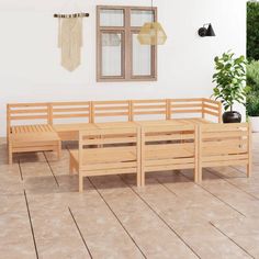 a wooden bench sitting on top of a hard wood floor next to a potted plant