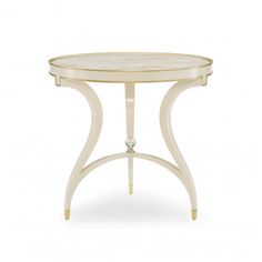 a white table with a glass top and gold trimmings on the bottom half