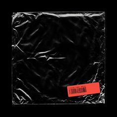 a black plastic bag with a red sticker on it