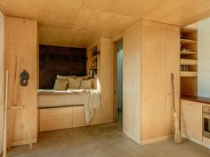 a bedroom with wood paneling and built - in shelving