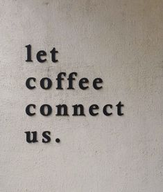 the words let coffee connect us written in black on a white wall