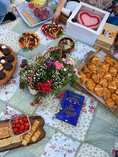 a table filled with lots of food on top of a white and blue table cloth