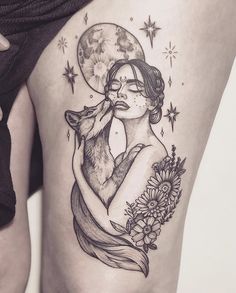 a woman with a wolf tattoo on her thigh