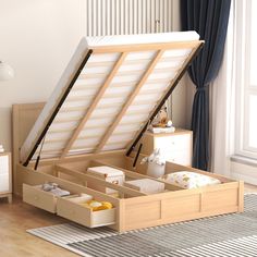 an open bed with drawers underneath it on the floor next to a rug and window