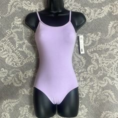 a female mannequin wearing a purple bodysuit on a gray and white background