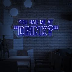 a neon sign that says you had me at w drink? in front of a brick wall