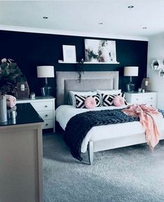 a black and white bedroom with pink accents