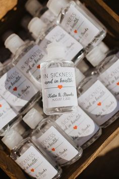 bottles of personalized hand sanitizers are on display for sale at a wedding