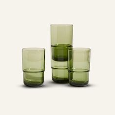 four green glasses sitting next to each other