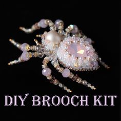 a beaded spider with pearls and beads on it's back, sitting in front of the words diy brooch kit