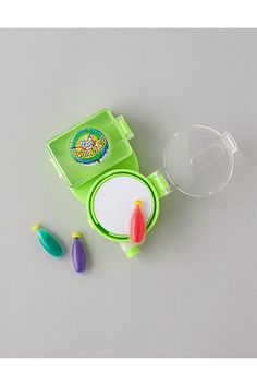 a green toy set with three plastic objects