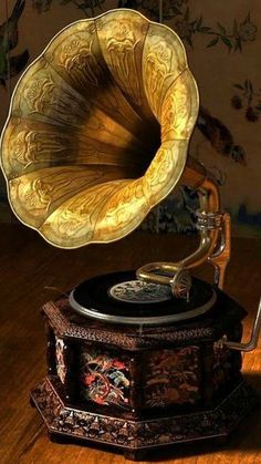 an old phonograph sitting on top of a wooden table