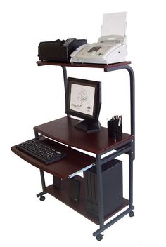 a computer desk with a keyboard, mouse and monitor on it next to a printer