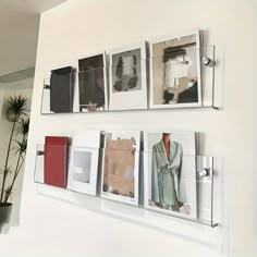 there are pictures hanging on the wall with clips to hang them in front of each other