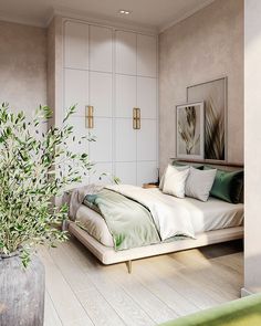 a bedroom with a bed, plant and pictures on the wall