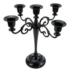 a black candelabra with six candles on it's base and an ornate design