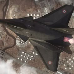 an aerial view of a fighter jet flying in the sky over some buildings and roads