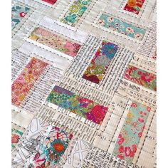 a close up of a patchwork quilt with many different colors and designs on it