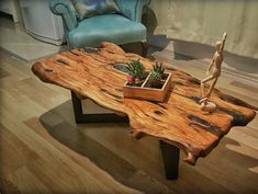 a wooden table sitting on top of a hard wood floor next to a blue chair