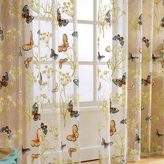 the curtains are decorated with butterflies on them