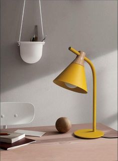 a yellow lamp sitting on top of a wooden table