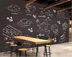 a restaurant with chalkboard walls and wooden tables