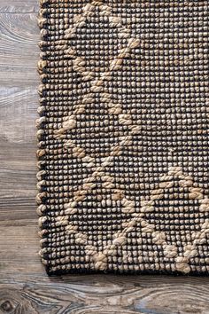 an area rug on top of a wooden floor next to a bottle opener and pen