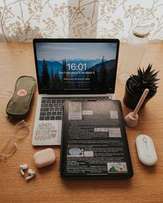 an open laptop computer sitting on top of a wooden desk next to a mouse and other items