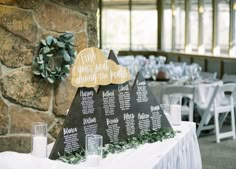 a table set up with seating cards and place settings