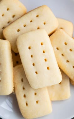 some crackers are on a white plate and have holes in the middle of them