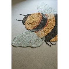 a close up of two rugs with a bee on one and a bum on the other