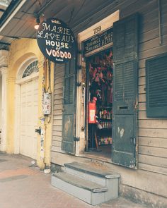 a store front with shutters open on the outside and sign above it that says margie's famous mouse voodoo